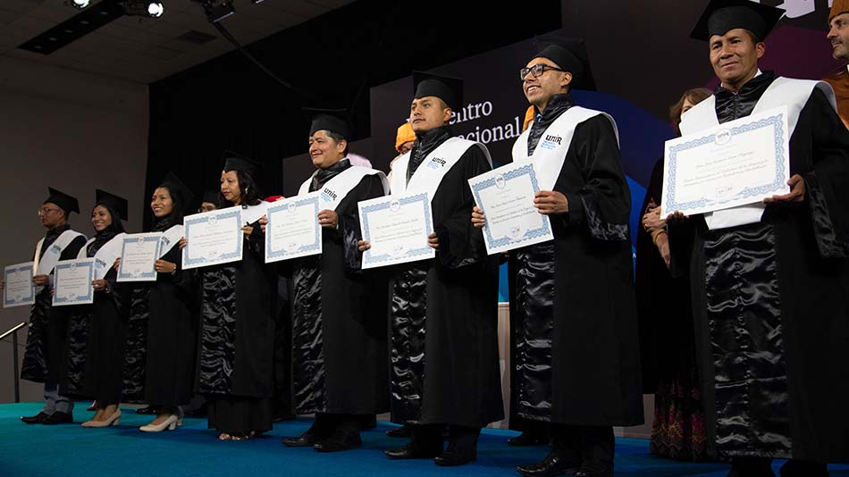 Egresados posan orgullosos con sus diplomas en el Encuentro Internacional Alumni 2024.