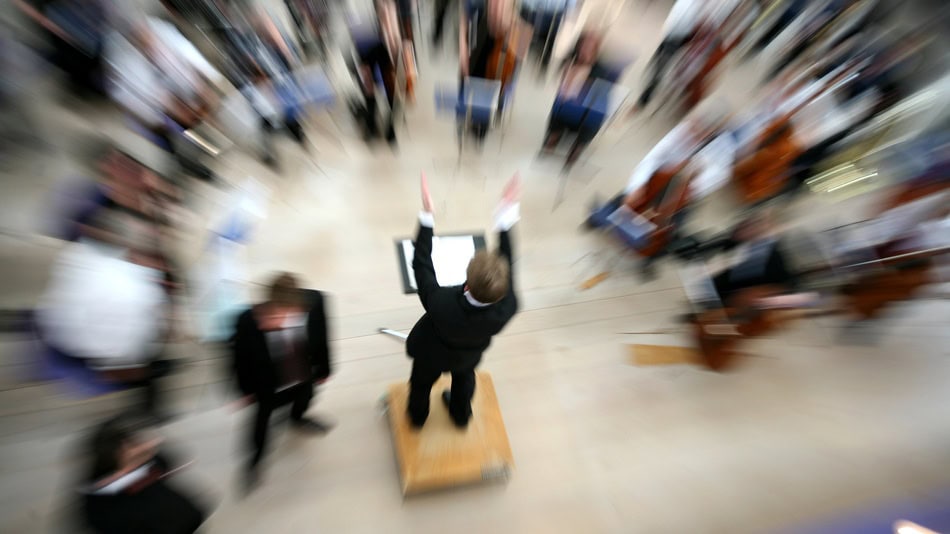 El director de orquesta es la persona que debe conseguir que múltiples intérpretes conviertan simultáneamente una partitura en una interpretación coherente